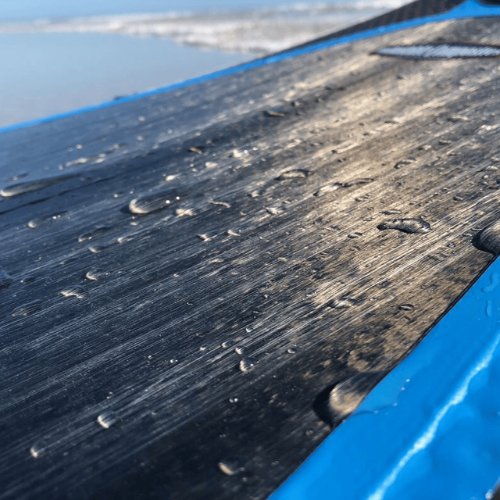 Close-up of Air Core Composite deck material, wet with water droplets